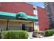 Building entrance featuring a well-kept facade with the address displayed on the green awning at 200 N Pearl St # 205, Denver, CO 80203