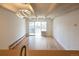Bright living room with hardwood floors and modern light fixture and sliding glass door at 200 N Pearl St # 205, Denver, CO 80203