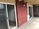 Patio area with red brick exterior and sliding glass doors leading to the interior at 200 N Pearl St # 205, Denver, CO 80203