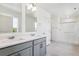 Modern primary bathroom with double vanity, quartz countertops, and glass-enclosed shower at 1038 Scotts Peak Dr, Berthoud, CO 80513