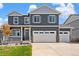 Beautiful two-story home with a three car garage, porch, and manicured front lawn at 1038 Scotts Peak Dr, Berthoud, CO 80513