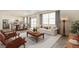 Bright living room with lots of natural light and an open floor plan to the kitchen and dining area at 1038 Scotts Peak Dr, Berthoud, CO 80513