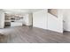 Open living space with luxury vinyl plank flooring flowing from living room to the kitchen at 1038 Scotts Peak Dr, Berthoud, CO 80513