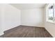 Empty room with hard surface flooring, neutral walls, and a window with natural light at 1038 Scotts Peak Dr, Berthoud, CO 80513