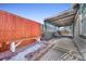 Partially covered patio area with adjacent wood fence and seating at 2017 Tulane St, Denver, CO 80260