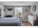 Bright bedroom with a queen-size bed and additional seating at 2017 Tulane St, Denver, CO 80260