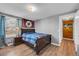 Bright bedroom with hardwood floors and access to hallway at 2017 Tulane St, Denver, CO 80260