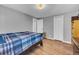 Cozy bedroom featuring hardwood floors and ample closet space at 2017 Tulane St, Denver, CO 80260