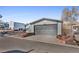 Home exterior showcasing a gray garage and landscaping at 2017 Tulane St, Denver, CO 80260