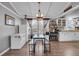 Kitchen with white cabinets and a charming chandelier at 2017 Tulane St, Denver, CO 80260