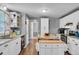 Bright eat-in kitchen with island and white cabinetry at 2017 Tulane St, Denver, CO 80260