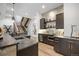 Modern wet bar featuring stone countertops, beverage fridge, and custom cabinets at 1207 Wildcat Bend Ct, Castle Rock, CO 80108