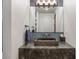 Stylish bathroom features a unique stone vessel sink atop a marbled countertop at 1207 Wildcat Bend Ct, Castle Rock, CO 80108