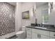 Modern bathroom featuring a glass enclosed shower with gray hexagon tile and a gray vanity with a white sink at 1207 Wildcat Bend Ct, Castle Rock, CO 80108