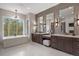 Bright bathroom features double vanities, decorative wall tile, and a soaking tub overlooking a wooded lot at 1207 Wildcat Bend Ct, Castle Rock, CO 80108