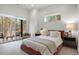 Bright bedroom with white shiplap walls, a large window, a sliding door and a red upholstered bed frame at 1207 Wildcat Bend Ct, Castle Rock, CO 80108