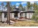 Stunning exterior of home with stone accents, modern design, and a beautifully landscaped front yard at 1207 Wildcat Bend Ct, Castle Rock, CO 80108