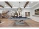 Stylish game room with pool table, exposed beam ceiling, and adjacent wet bar, ideal for entertainment at 1207 Wildcat Bend Ct, Castle Rock, CO 80108