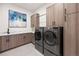 Well-appointed laundry room featuring modern appliances and ample cabinet space at 1207 Wildcat Bend Ct, Castle Rock, CO 80108