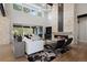 Bright and airy living room with fireplace, outdoor view, and stylish decor at 1207 Wildcat Bend Ct, Castle Rock, CO 80108