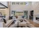 Bright and airy living room featuring a fireplace, comfortable seating, and access to the outdoor deck at 1207 Wildcat Bend Ct, Castle Rock, CO 80108