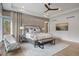 Luxurious main bedroom featuring a large bed, seating area, and accent wall at 1207 Wildcat Bend Ct, Castle Rock, CO 80108