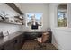 Bright home office with built-in desk, shelving, and a large window at 1207 Wildcat Bend Ct, Castle Rock, CO 80108