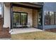 Cozy covered patio with stone accents featuring outdoor seating and lush landscaping at 1207 Wildcat Bend Ct, Castle Rock, CO 80108