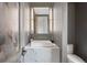 Stylish powder room with floating vanity, geometric tile backsplash, and modern fixtures at 1207 Wildcat Bend Ct, Castle Rock, CO 80108