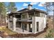 Beautiful rear exterior showcasing a multi-level deck, stone accents, and modern design at 1207 Wildcat Bend Ct, Castle Rock, CO 80108