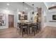 Charming wet bar with stone accents, pendant lighting, and seating for four, adjacent to living area at 1207 Wildcat Bend Ct, Castle Rock, CO 80108