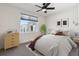 Serene bedroom featuring a large window, natural light, and stylish decor at 1222 S Reed Way, Lakewood, CO 80232