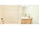 Clean bathroom featuring shower-tub combo, tiled walls, and single sink vanity at 1748 Eagle St # B, Aurora, CO 80011