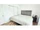 Bedroom features laminate floors, closet with bi-fold doors, and queen-sized bed at 1748 Eagle St # B, Aurora, CO 80011