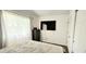 Well lit bedroom featuring a large window and mounted tv at 1748 Eagle St # B, Aurora, CO 80011