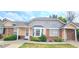 Charming exterior of a townhome featuring a well-maintained lawn and classic architectural details at 1748 Eagle St # B, Aurora, CO 80011