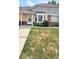 Quaint townhome featuring a bay window and established landscaping at 1748 Eagle St # B, Aurora, CO 80011