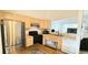 Well-lit kitchen with stainless steel appliances and bar top seating at 1748 Eagle St # B, Aurora, CO 80011