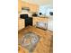 Spacious kitchen features wood cabinets, black appliances, and a breakfast nook at 1748 Eagle St # B, Aurora, CO 80011