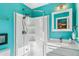 Bathroom with a teal walk-in shower and white vanity at 172 S Lowell Blvd, Denver, CO 80219