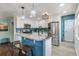 Modern kitchen with white cabinets, granite counters, and island at 172 S Lowell Blvd, Denver, CO 80219