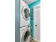 Stackable washer and dryer in a teal laundry room at 172 S Lowell Blvd, Denver, CO 80219