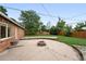 Spacious backyard with fire pit, patio area, and lush green lawn at 981 Ursula St, Aurora, CO 80011