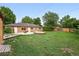 Expansive backyard with brick house, firepit, and grassy yard at 981 Ursula St, Aurora, CO 80011