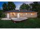 Exterior view of backyard featuring brick house and wooden deck at 981 Ursula St, Aurora, CO 80011