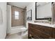 This cozy bathroom has a bathtub, shower, and an eye-catching sink with storage underneath at 981 Ursula St, Aurora, CO 80011