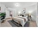This primary bedroom has neutral colors, an accent bench, and is connected to other rooms at 981 Ursula St, Aurora, CO 80011
