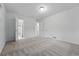 Spacious carpeted bedroom with multiple entry doors, and white trim at 981 Ursula St, Aurora, CO 80011