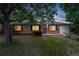 Beautiful brick home featuring a red front door, black shutters, and a well-maintained lawn at 981 Ursula St, Aurora, CO 80011