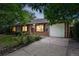 Charming brick home with a well-manicured front yard and a driveway leading to a single-car garage at 981 Ursula St, Aurora, CO 80011